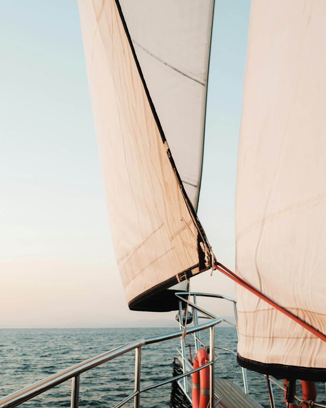 Sails catching the wind at sunset off Stavros